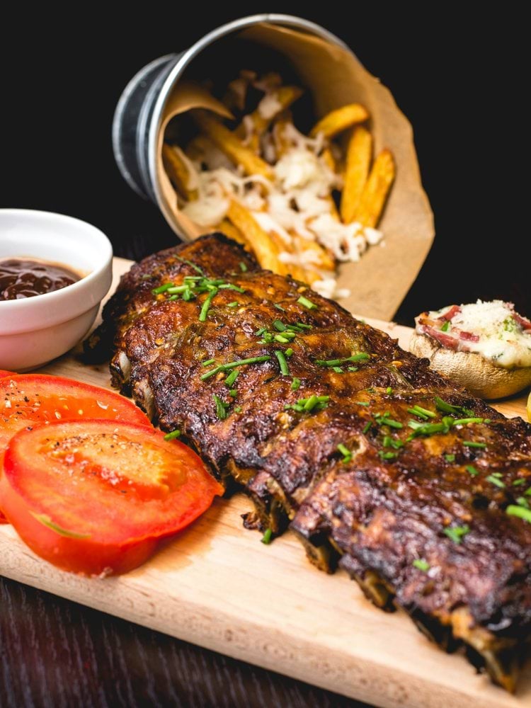 roasted ribs with sliced tomatoes and potatoes