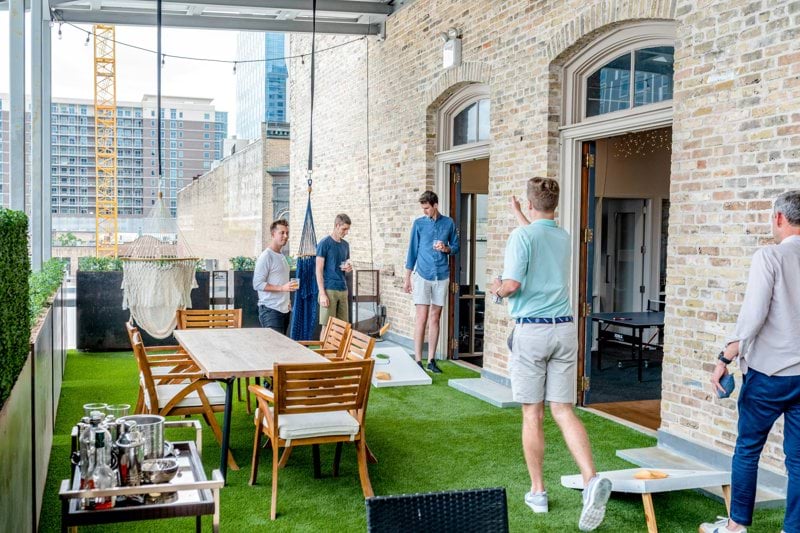 men playing cornhole boards