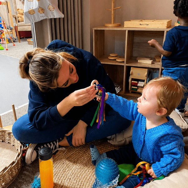 Staff interacting with child at nursery