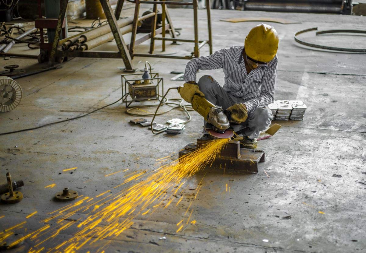 man using angle grinder