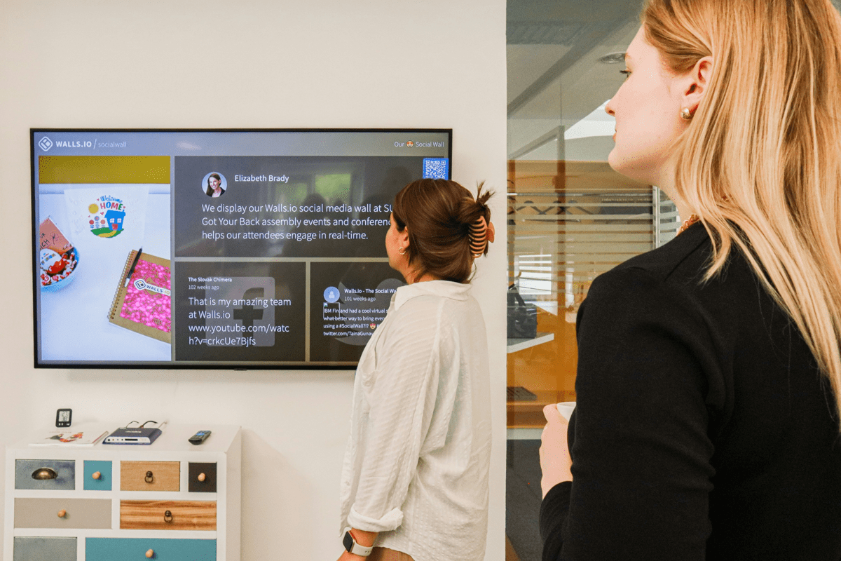 a woman standing in front of a flat screen tv