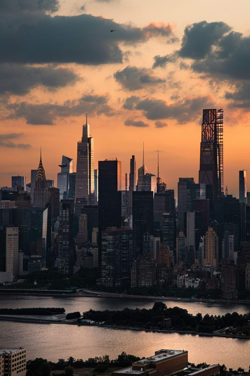 City skyline at sunset with dramatic clouds