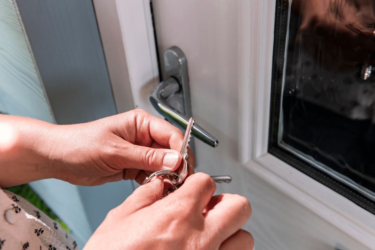 Tenants hands unlocking door to new home