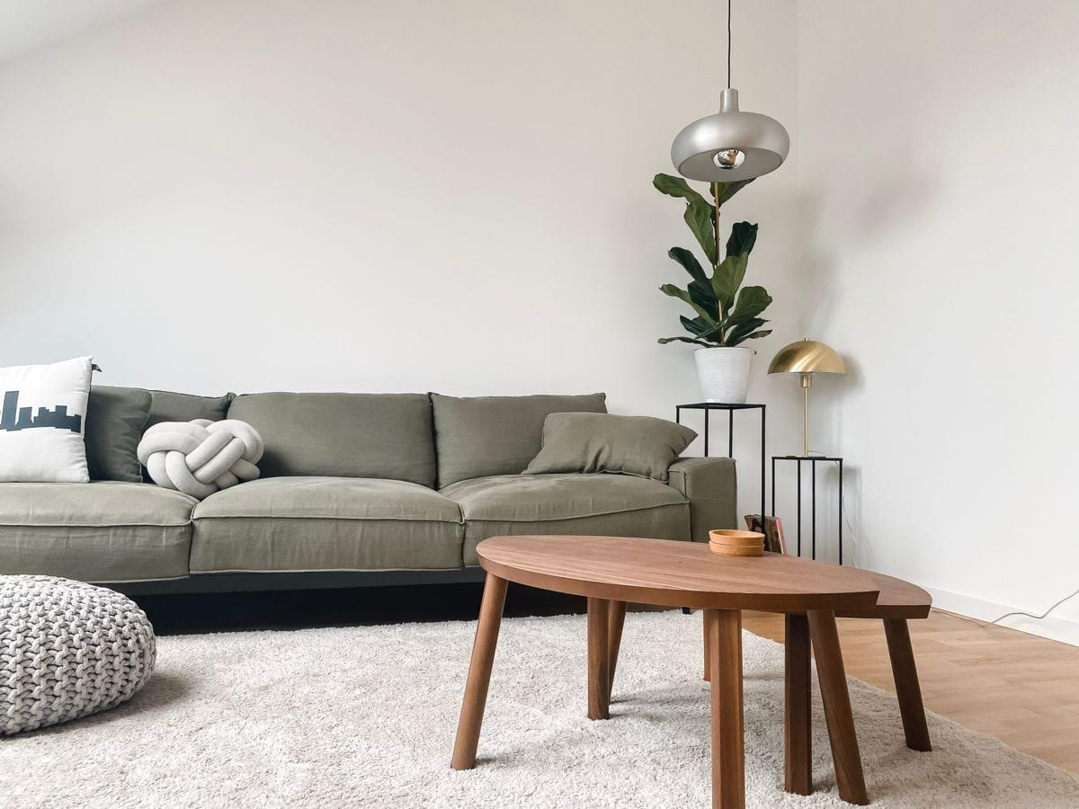 gray 2 seat sofa near brown wooden coffee table.jpg