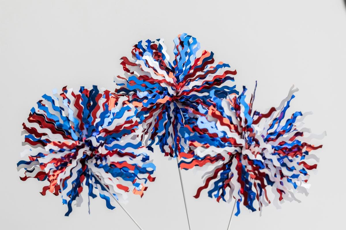 Two red, white and blue firecrackers in a vase