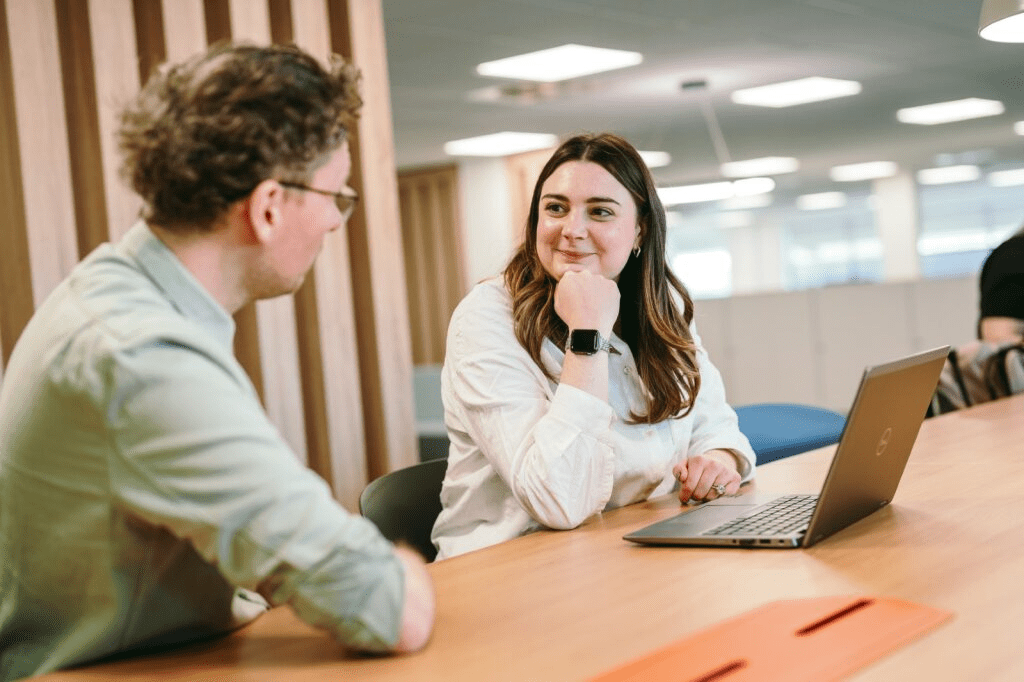 Colleagues collaborating in an open workspace