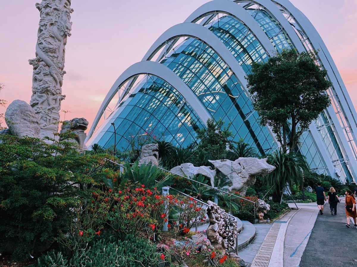 a garden with a glass building