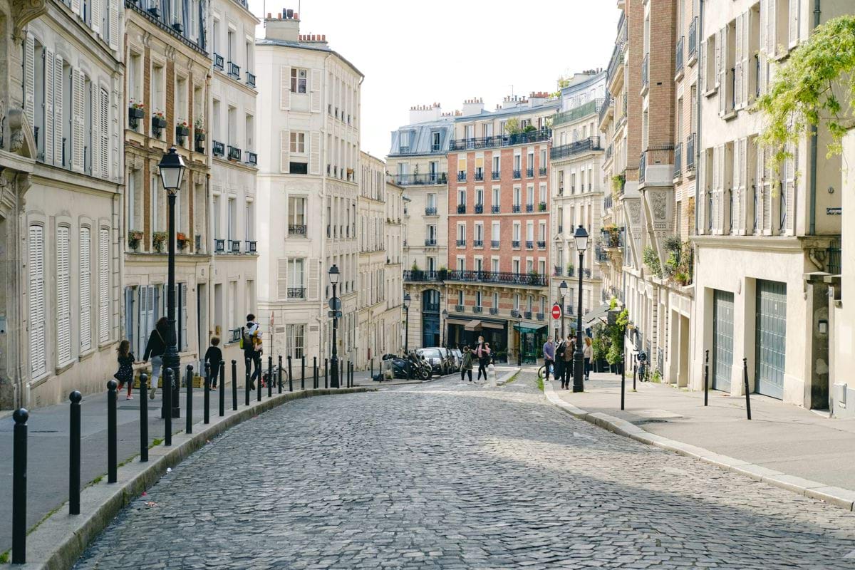 people walking on street between buildings during daytime