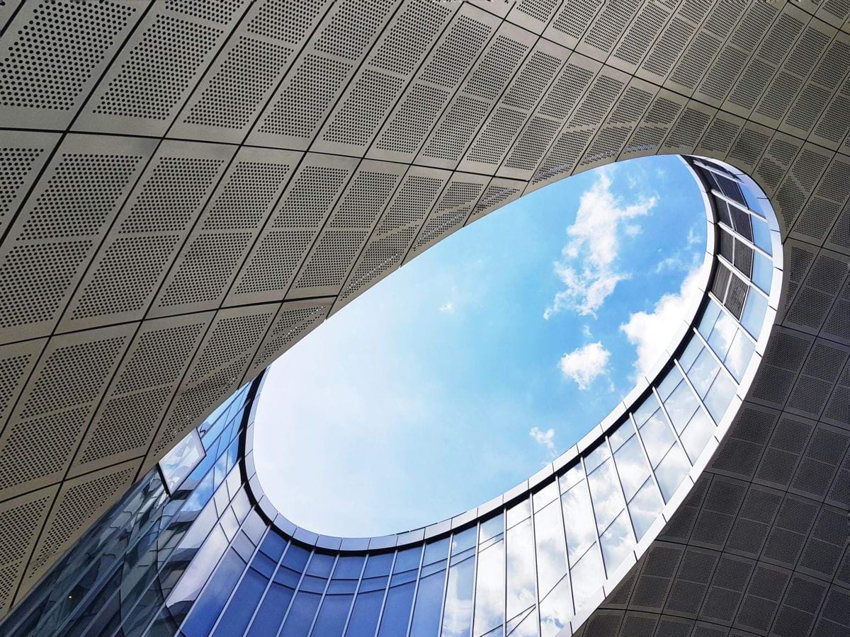 a building with a circular window and a sky background