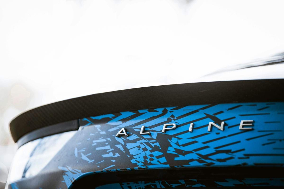 a close up of a blue and black car with the word alpine on it