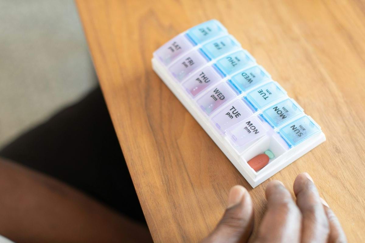 a hand holding a stack of paper money