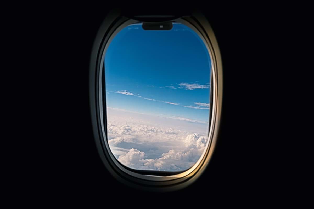 airline window viewing white clouds
