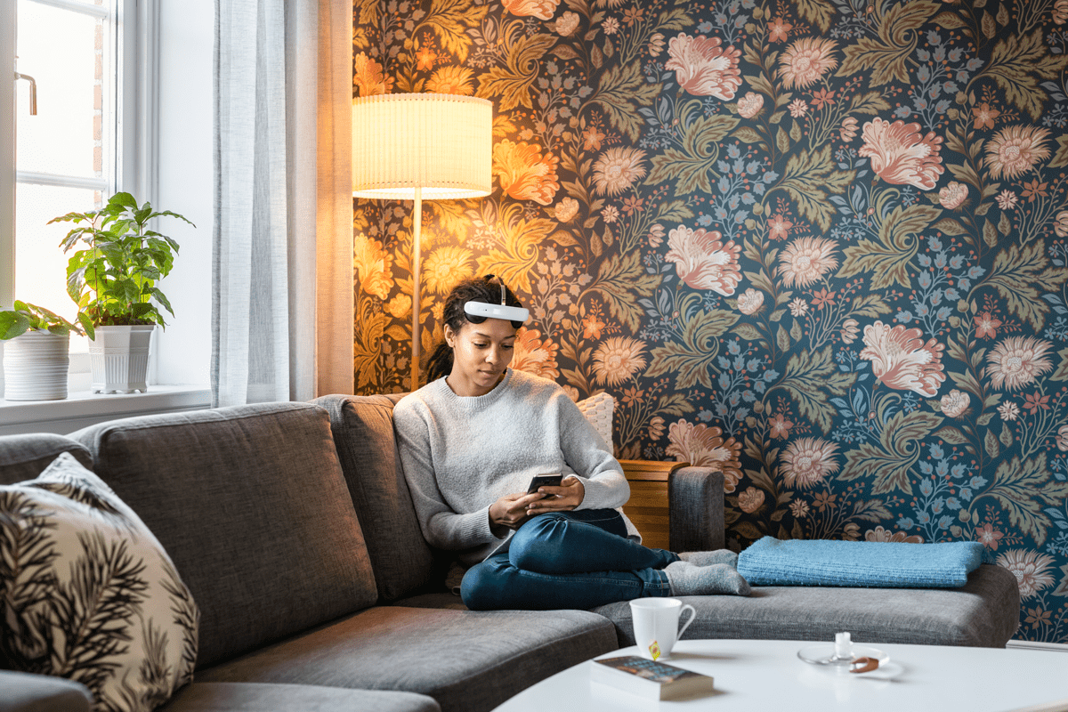 Woman using flow depression headset at home