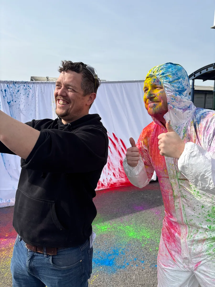 Team members celebrating at a colour run