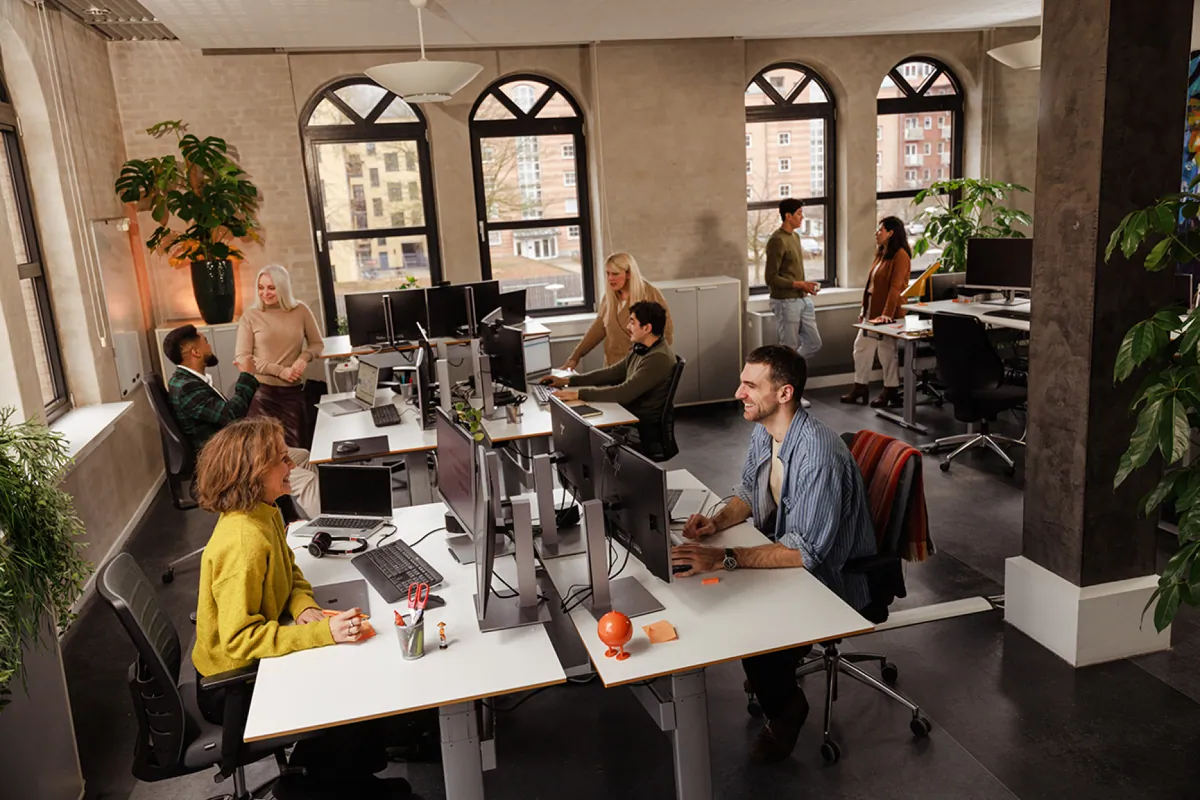 multilingual-team-open-plan-office-working-togetherwebp.webp