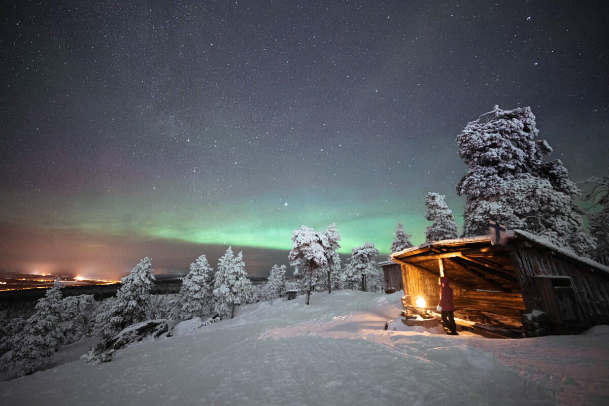 brown wooden house on snow covered ground during night time