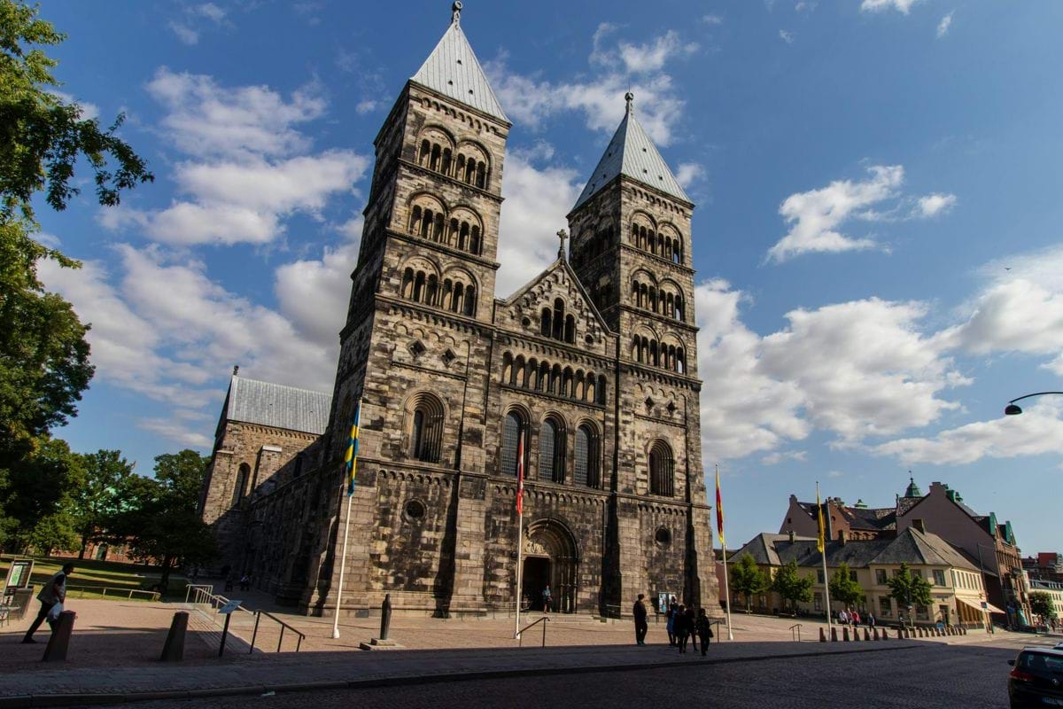 A tall church stands prominently under a sunny sky