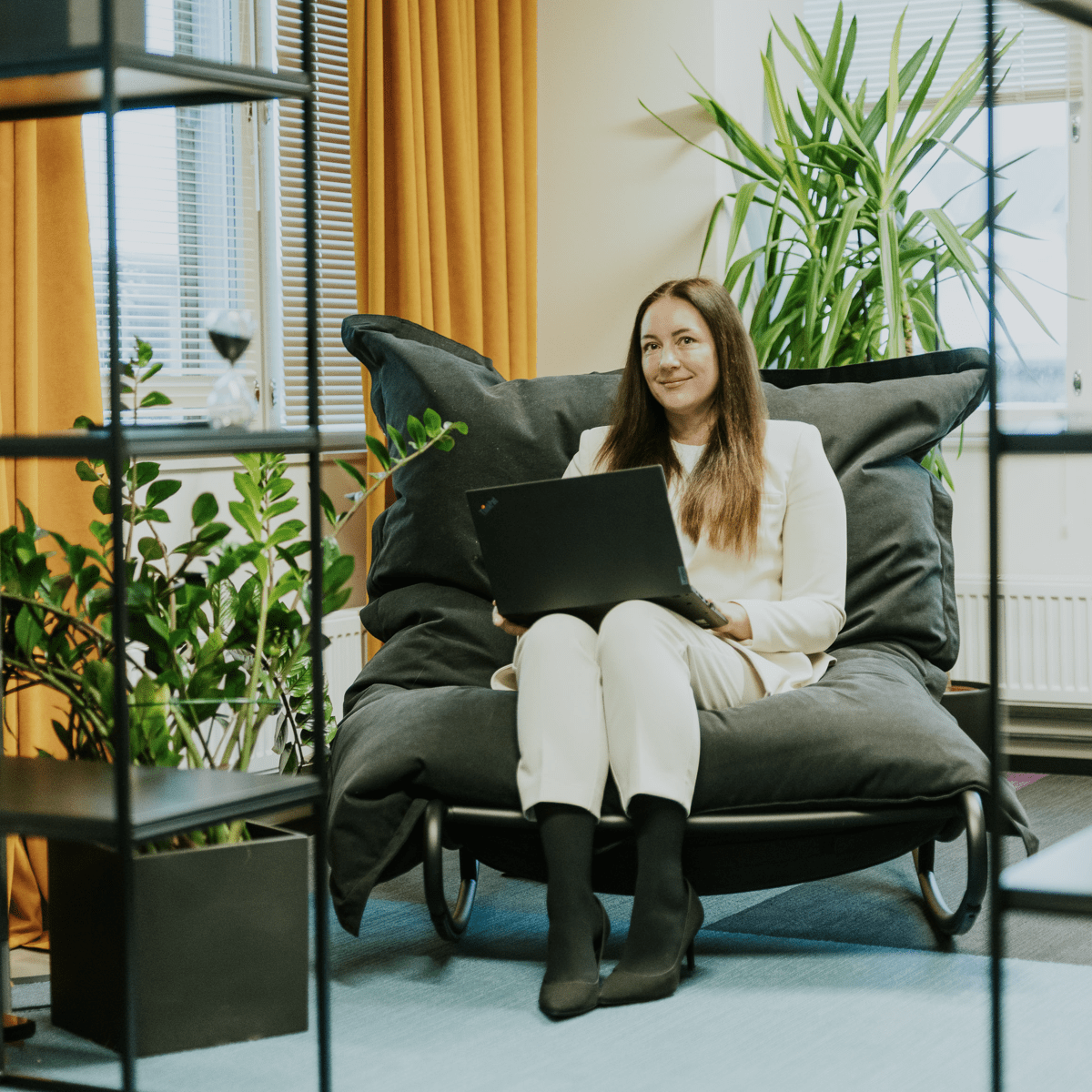 if insurance Tallinn office with a tech community member sitting in a comfortable dark chair