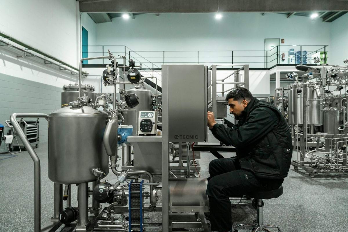 A man works on industrial machinery.