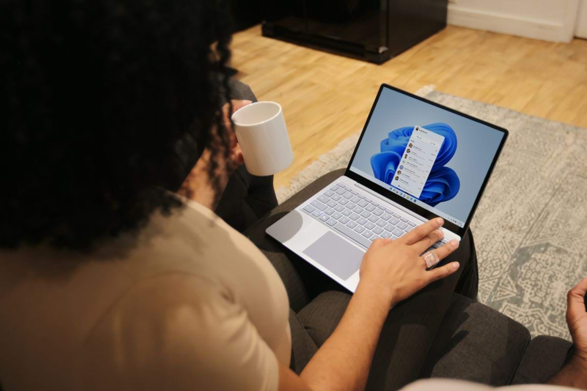 Female on her Microsoft laptop at work drinking coffee.jpg