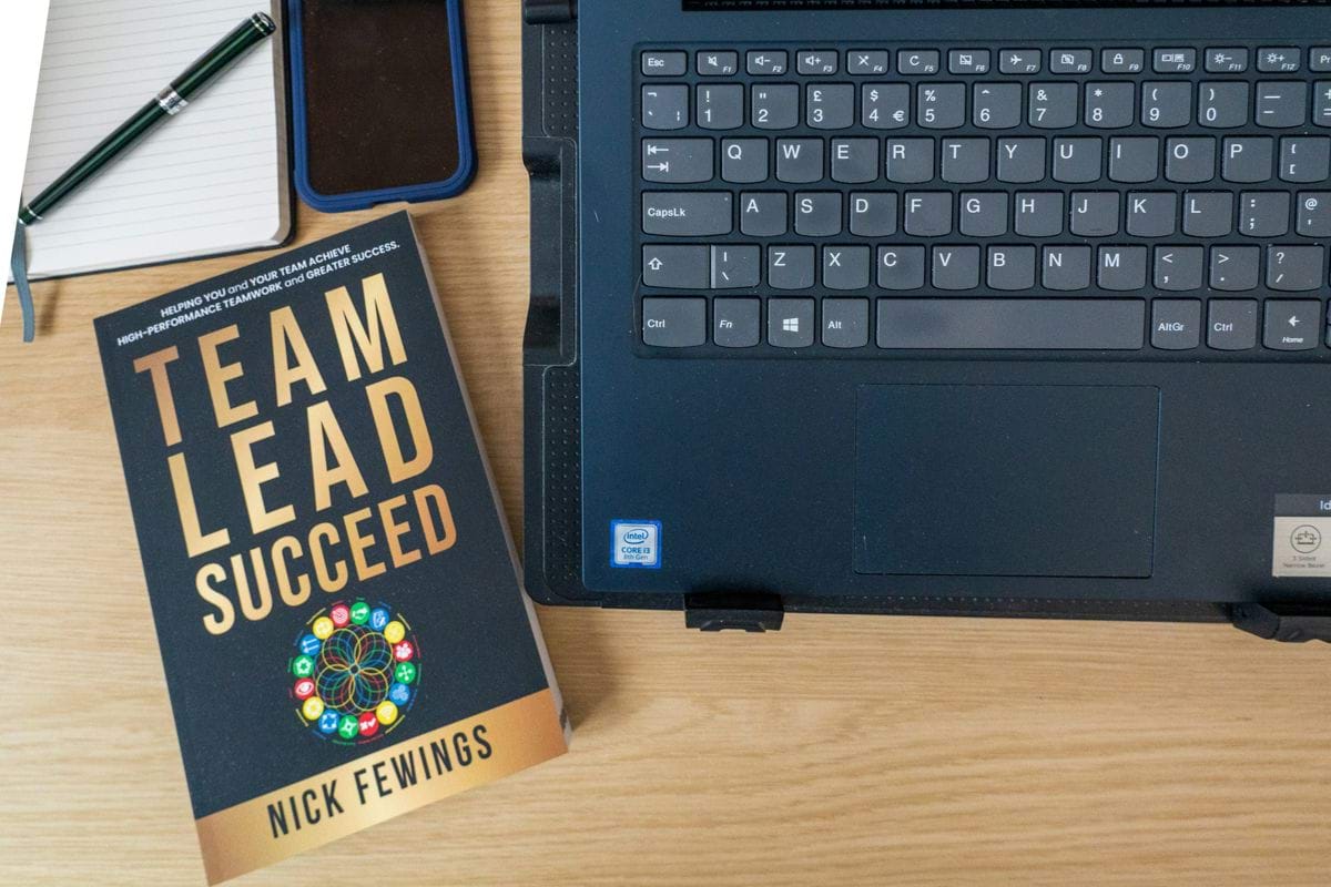 a book and a laptop on a table