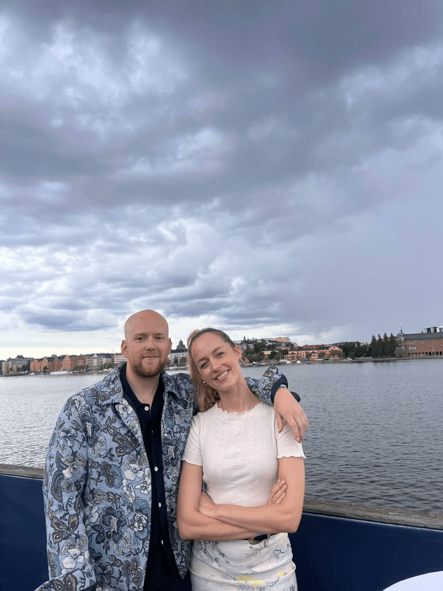 two people on a boat, next to sea