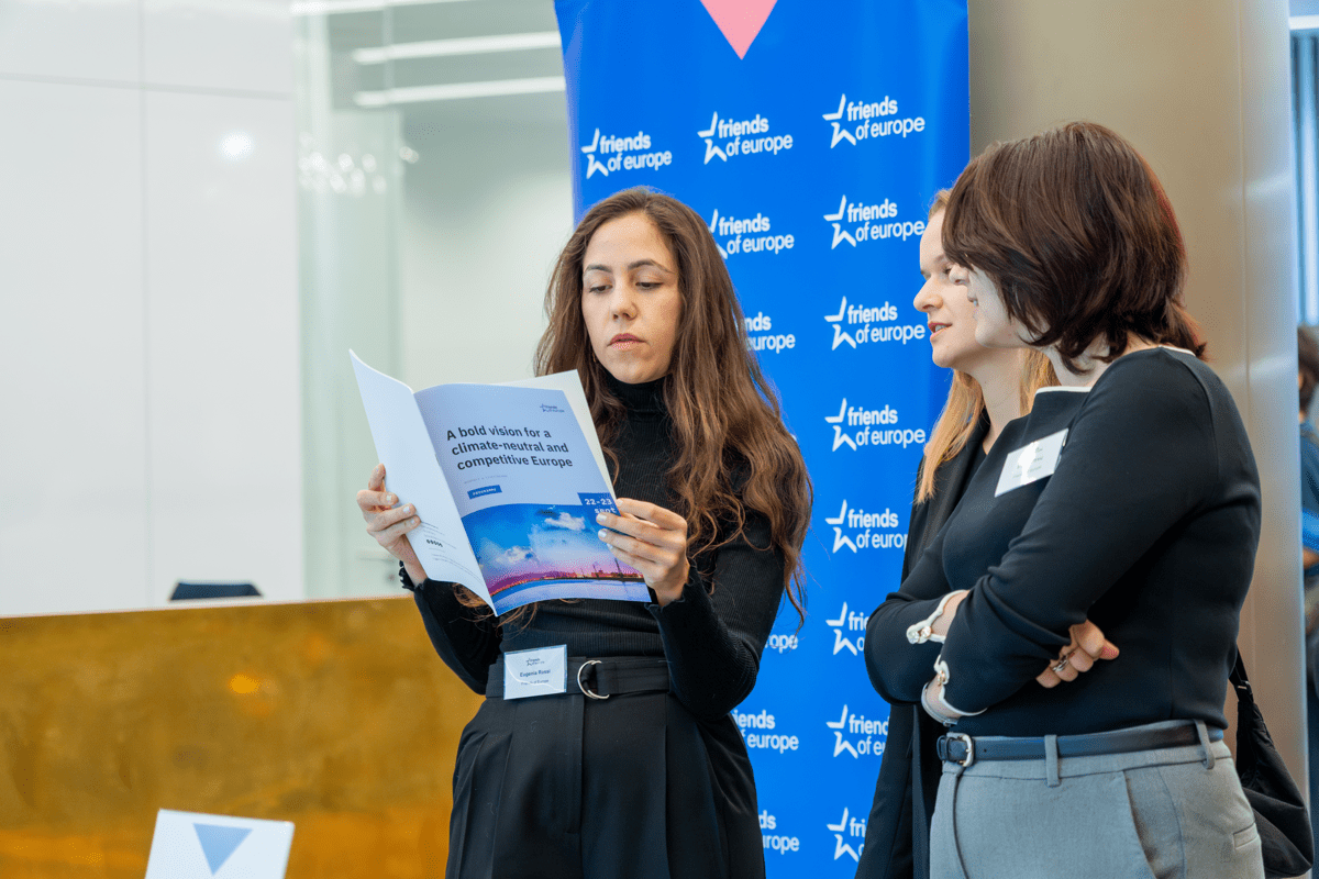 Three women read a brochure