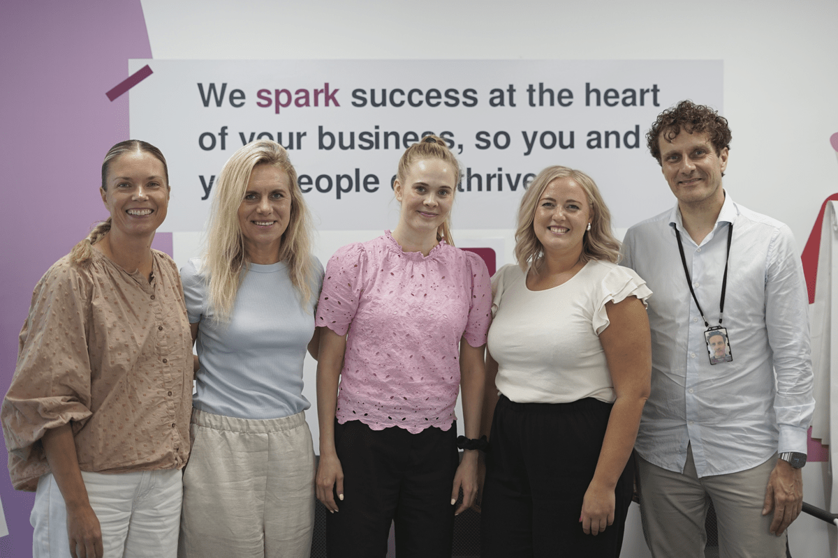 SD Worx professionals smiling together at the office