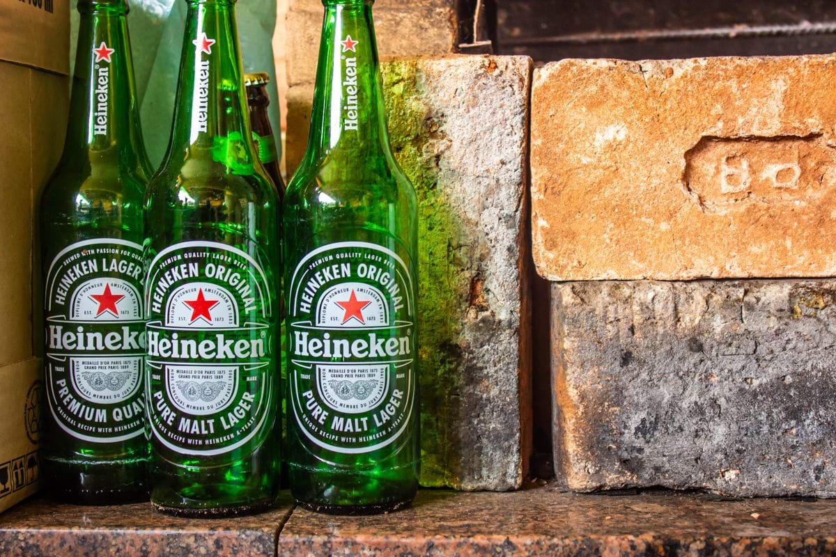 heineken bottle on brown concrete wall
