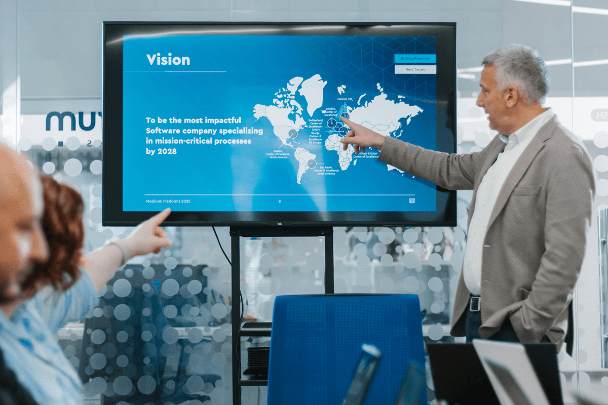 man explains company vision on screen
