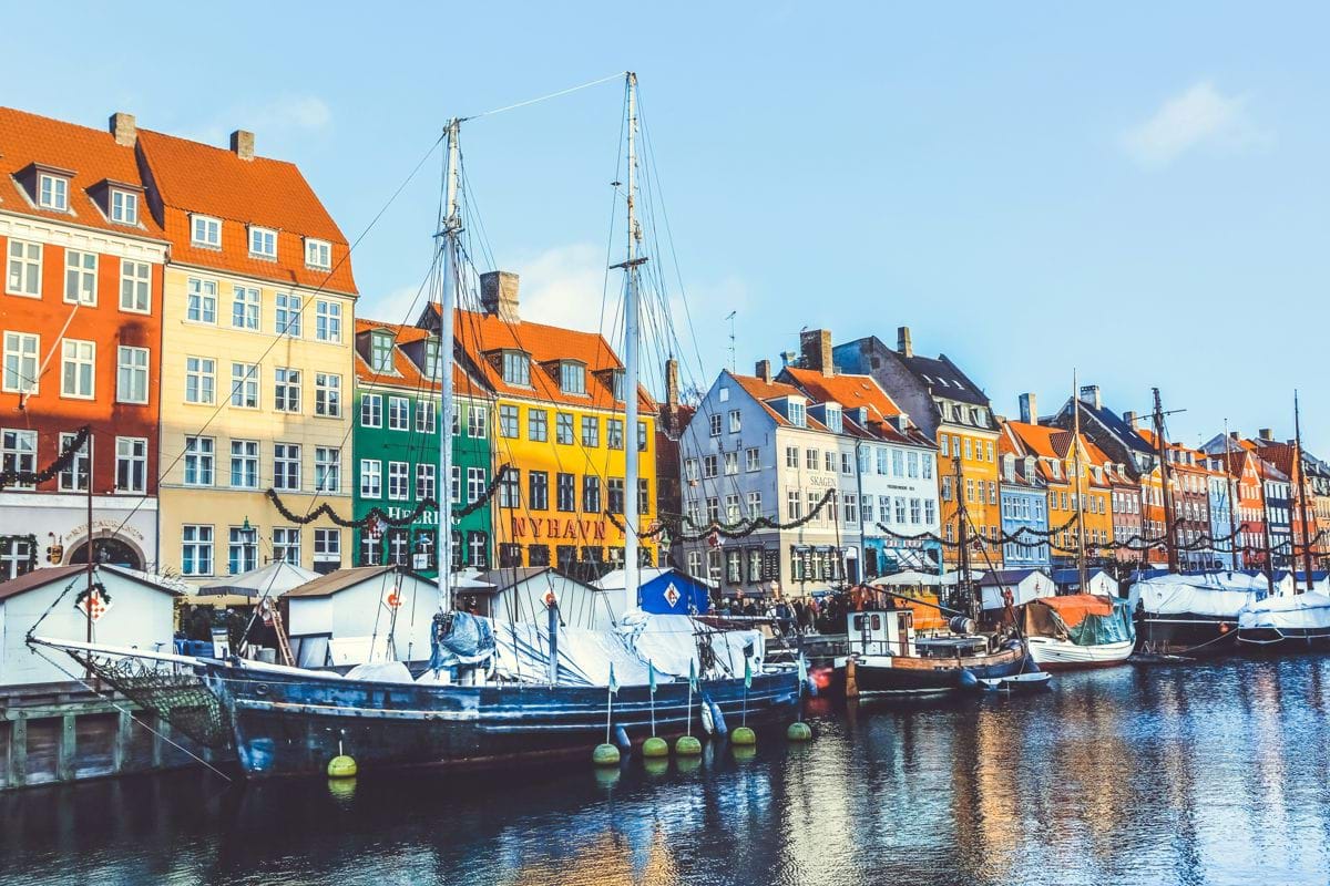 blue and white boat near buildings at daytime