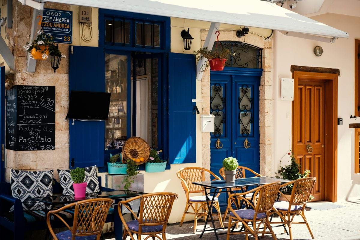 rattan armchairs outside blue doors