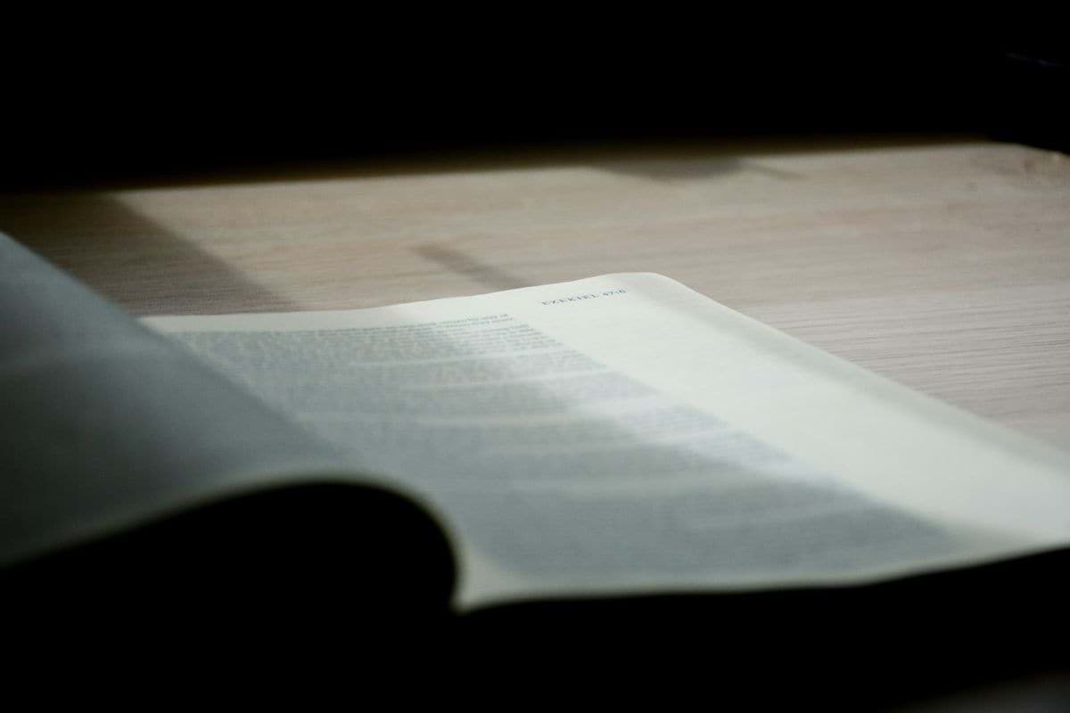 an open book sitting on top of a wooden table