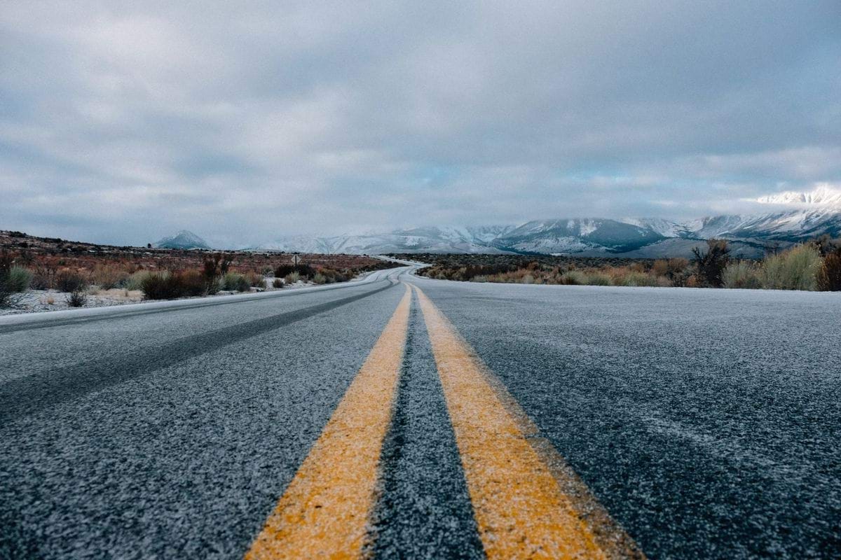 landscape photography of asphalt road under cloudy sky during daytime