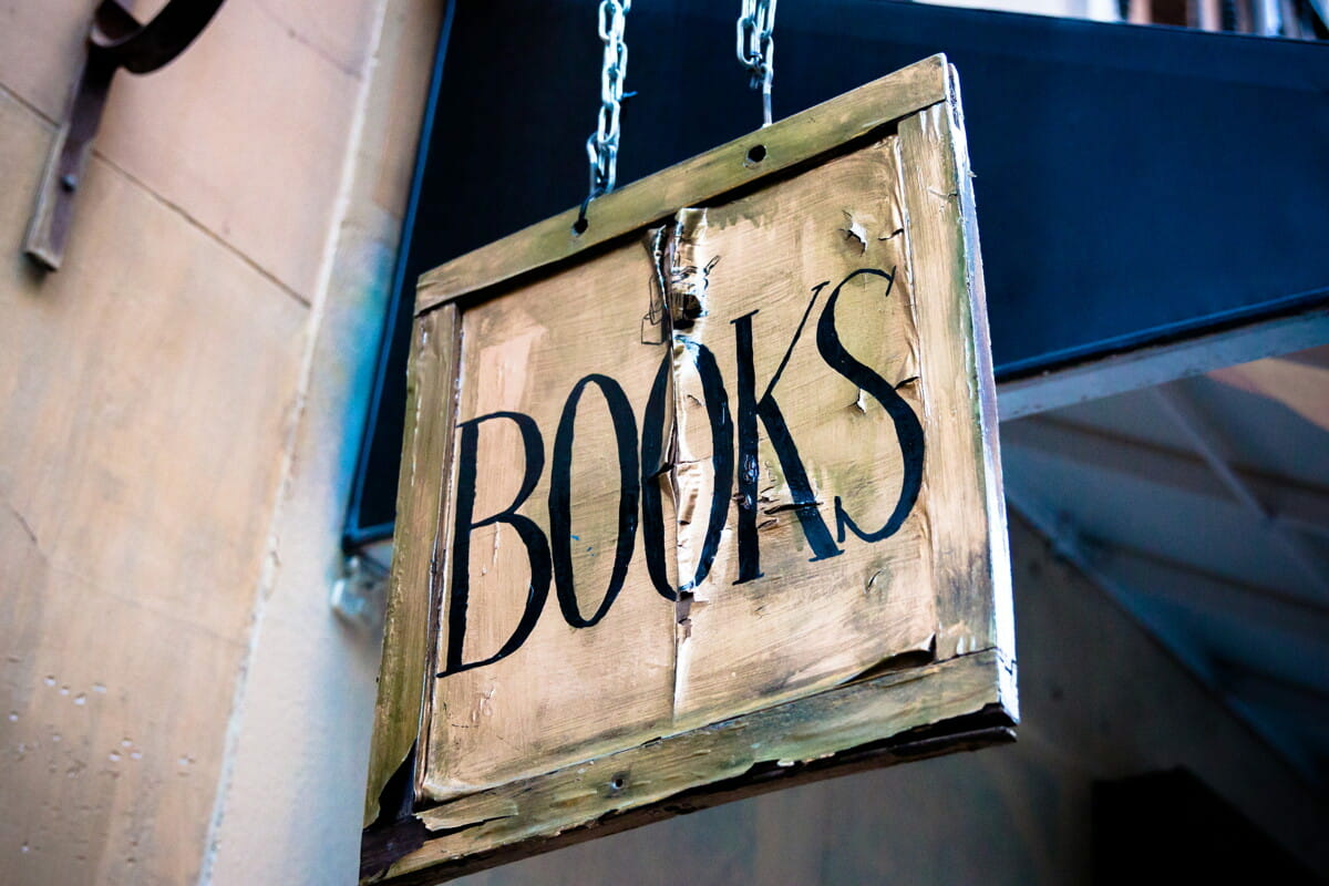 book signage hanging beside white wall