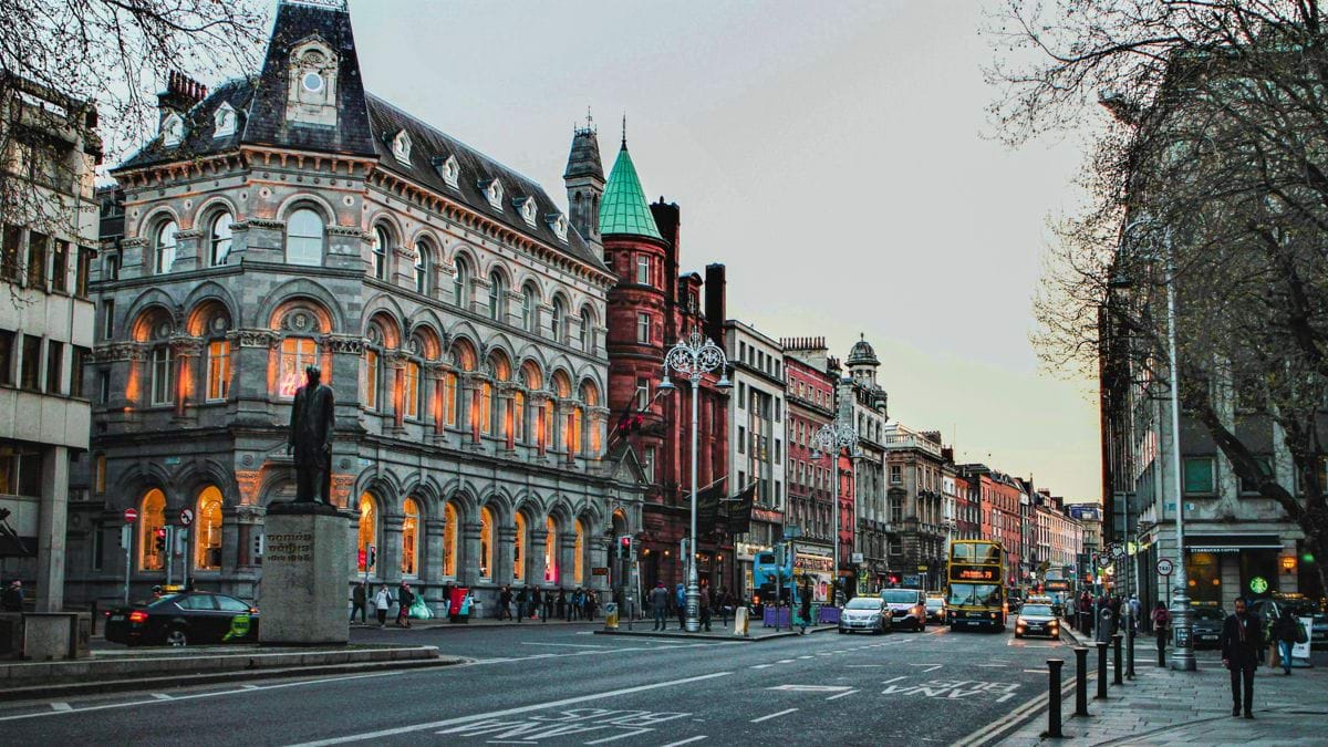 a city street with a clock tower in the middle of it