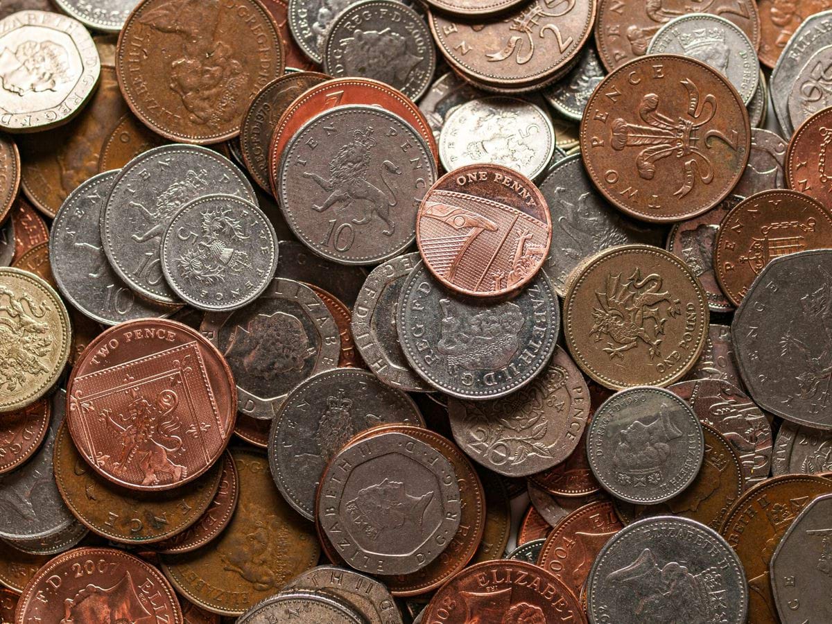 a pile of different types of coins