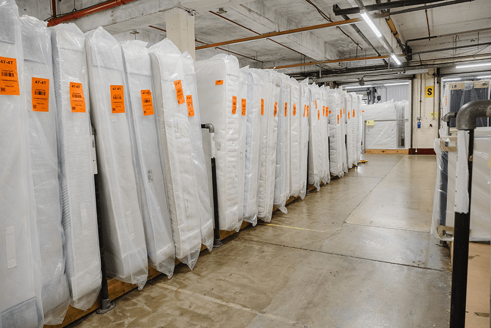 Rows of mattresses in a warehouse