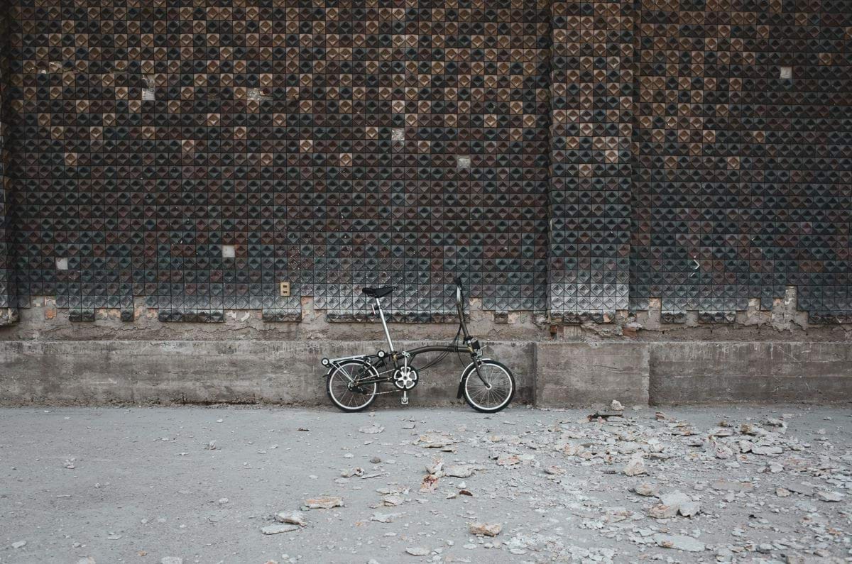 black bicycle on brown brick wall
