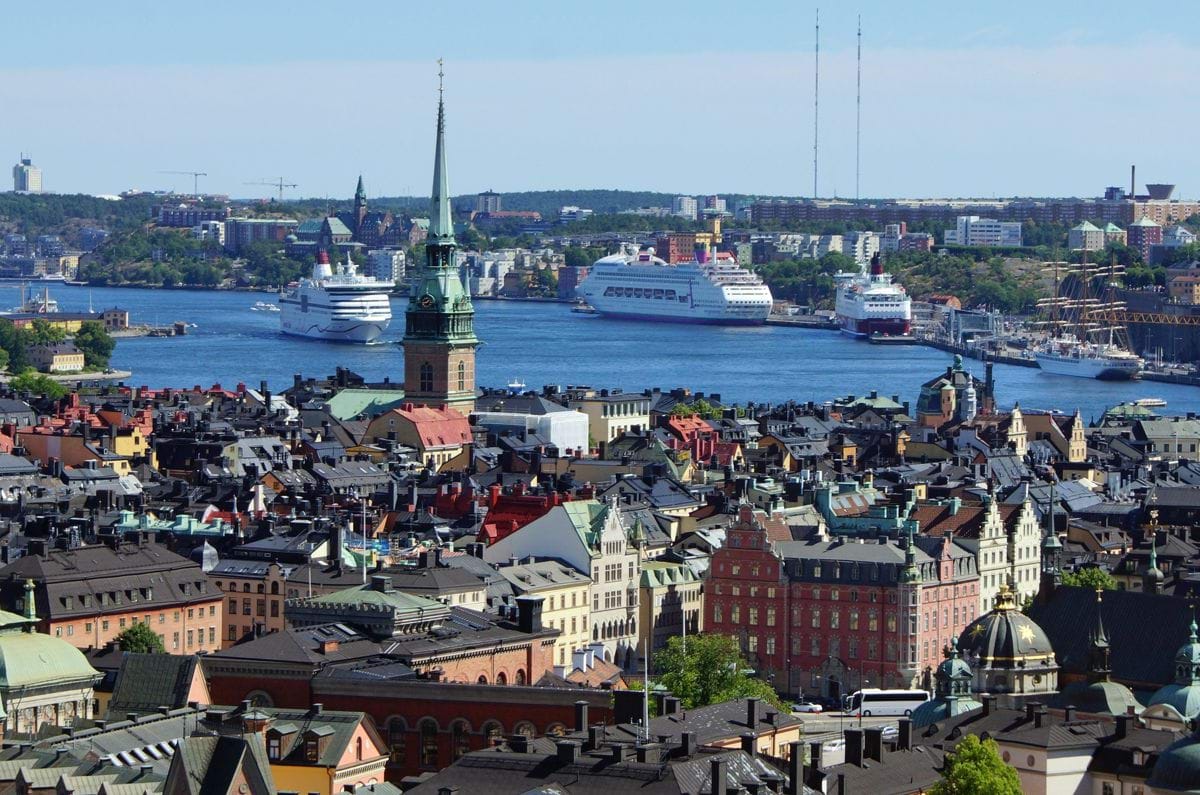 A view of a city with a large body of water in the background