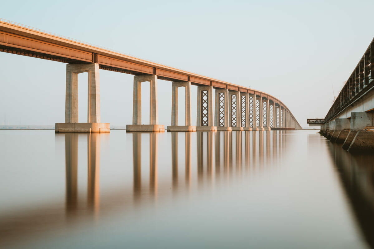 brown wooden bridge over body of water