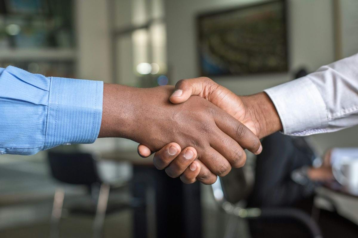 Two professionals shaking hands — Talent Connection NZ partners with SMEs as their recruitment partner
