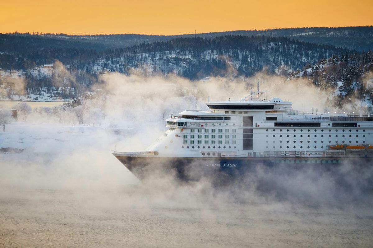 white and bleu cruise ship near mountain at daytime