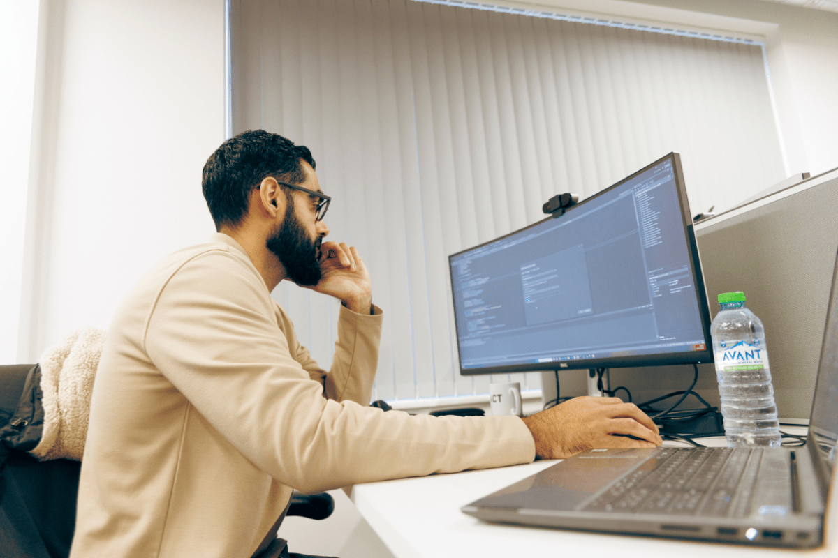 A man working intensively at his office desk on his computer
