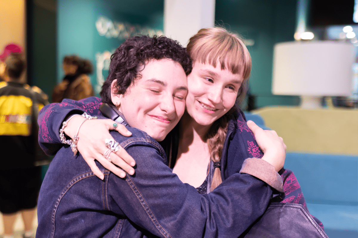 Two people embracing at Origins Festival