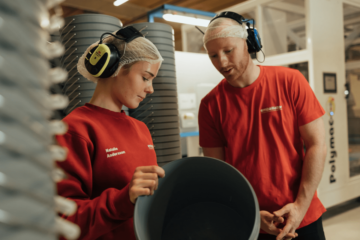 Two people discussing about a plastic pail