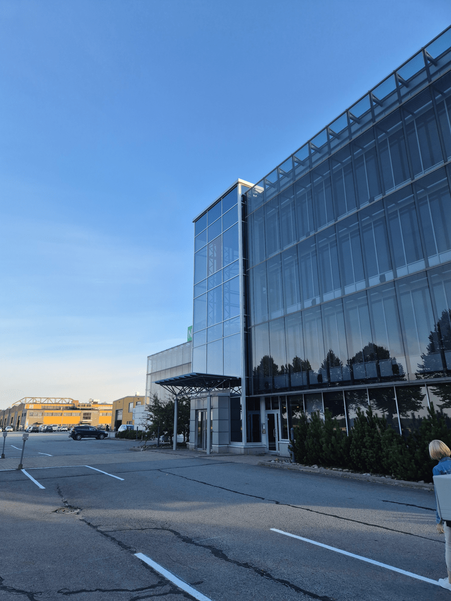 Nordec's big office building in Peräseinäjoki with sunlight hitting theglass exterior