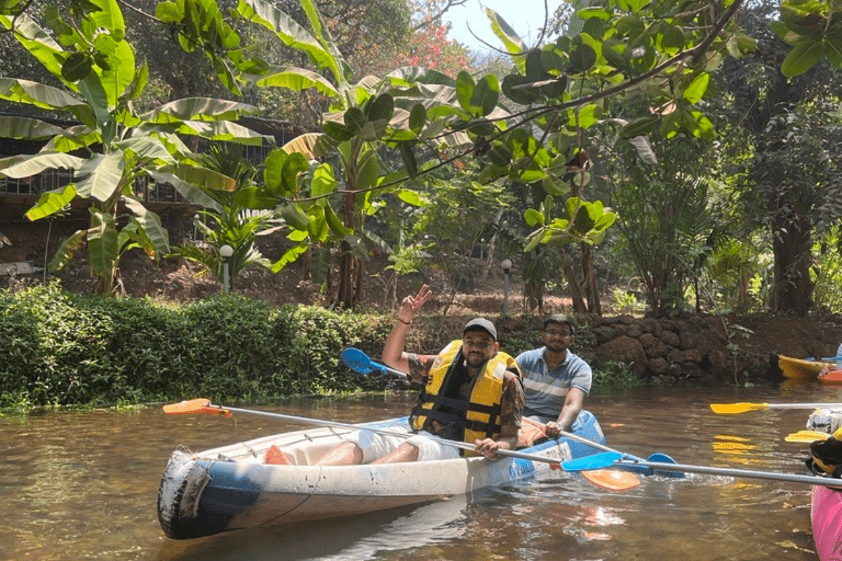 Two men canoeing in a tropical river