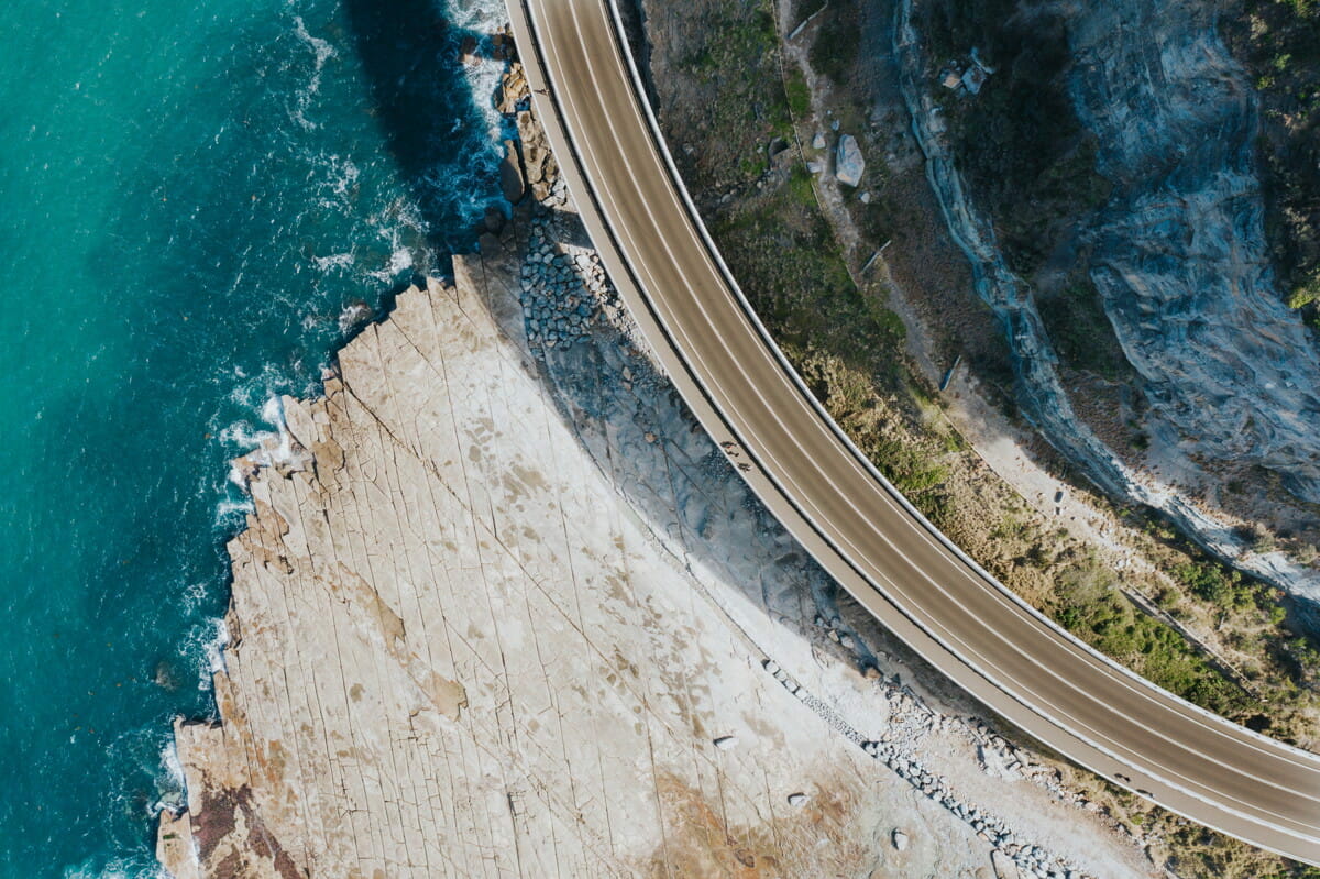 aerial view of road beside body of water