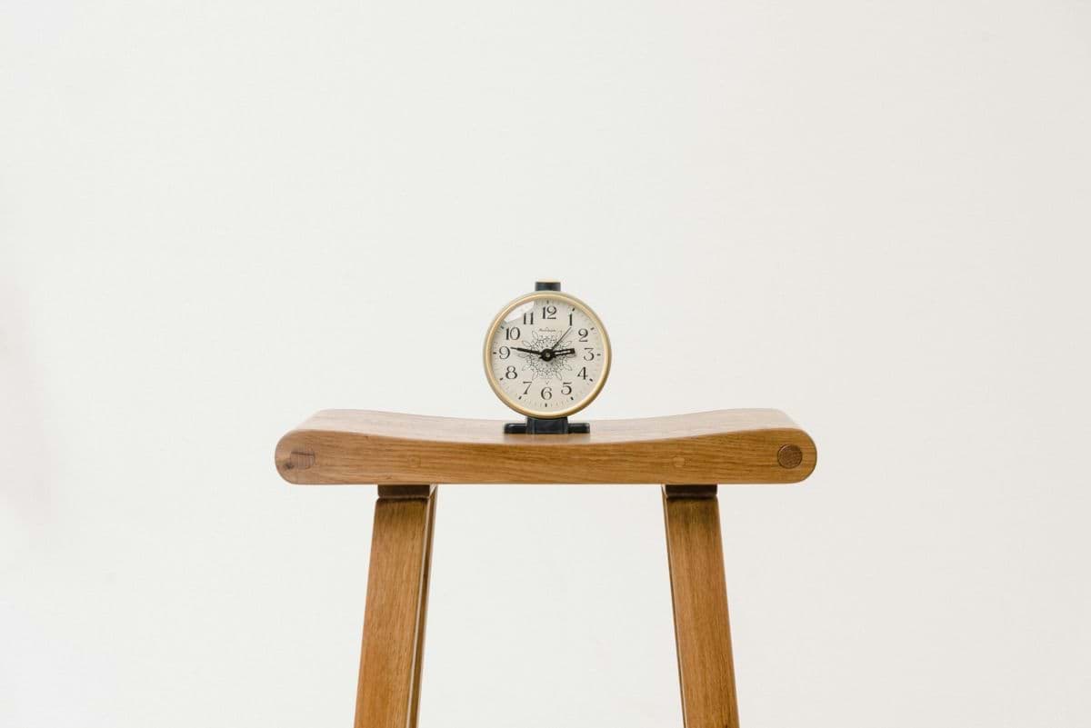 brown wooden table clock at 10 10